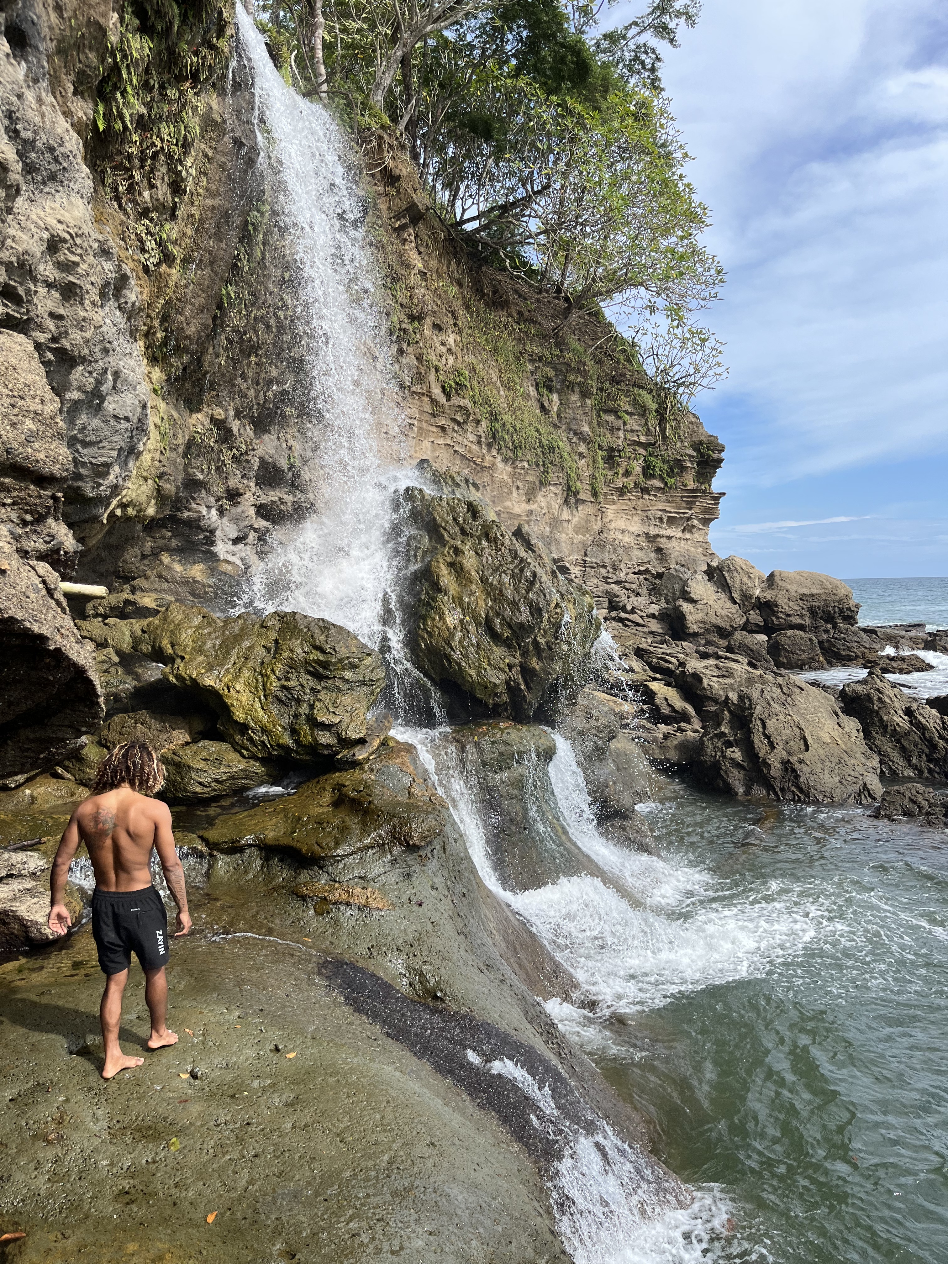 A hidden waterfall spilling into a swimming pool on the Nicoya Peninsula