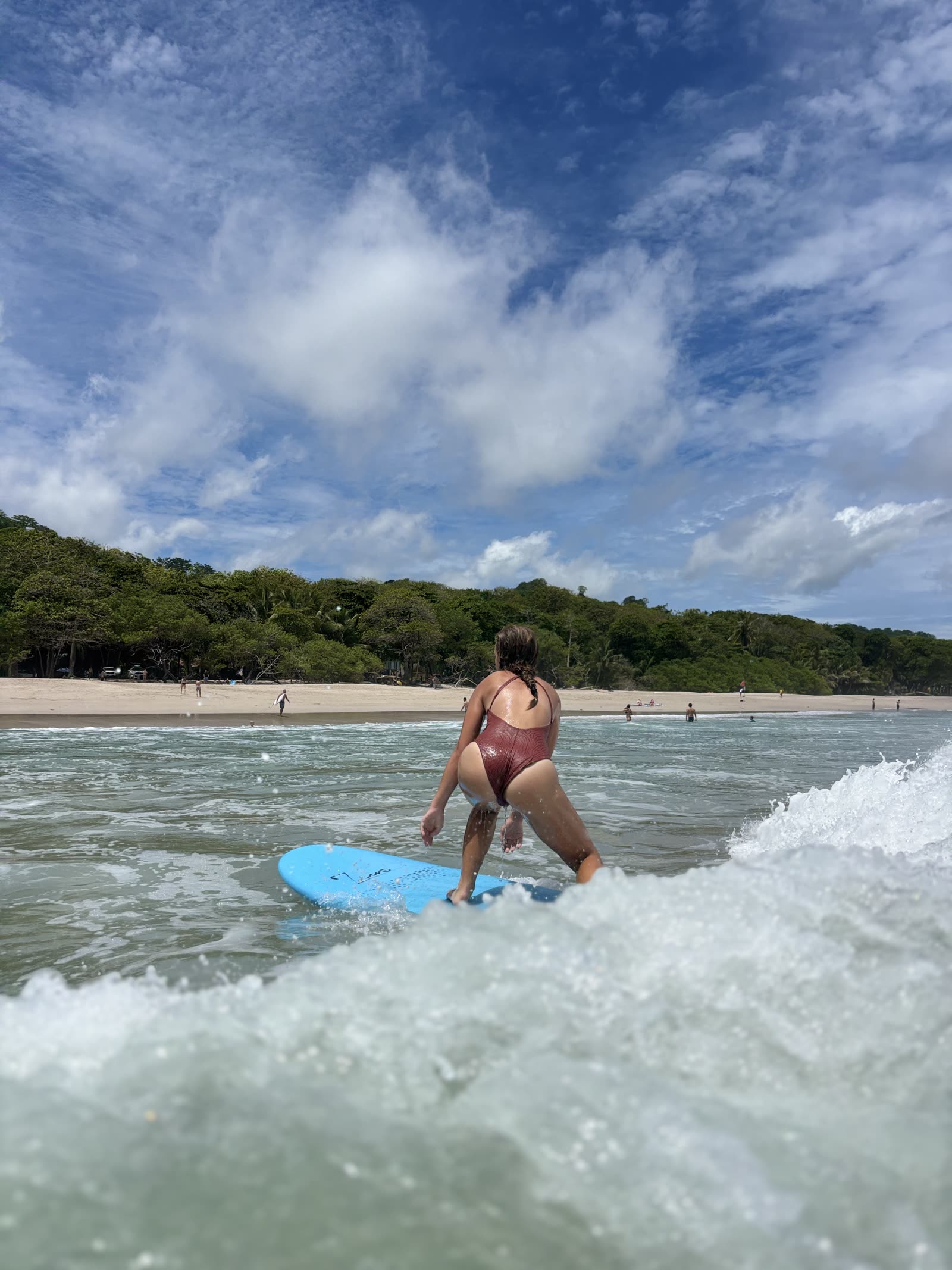 A guest standing up on a wave during a surf session in Santa Teresa