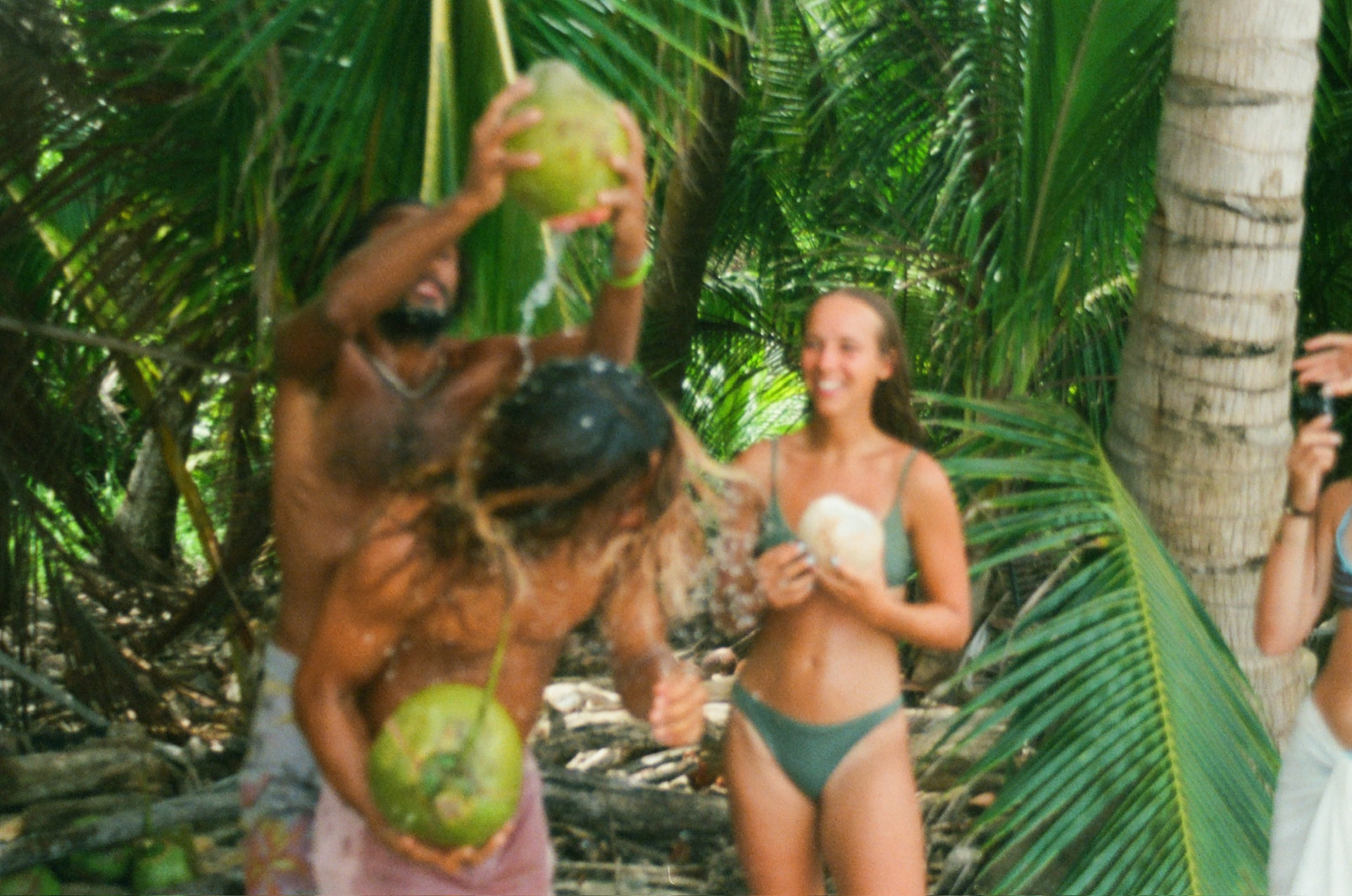 Crew cracking fresh coconuts under the palms on an ATV day out of Santa Teresa