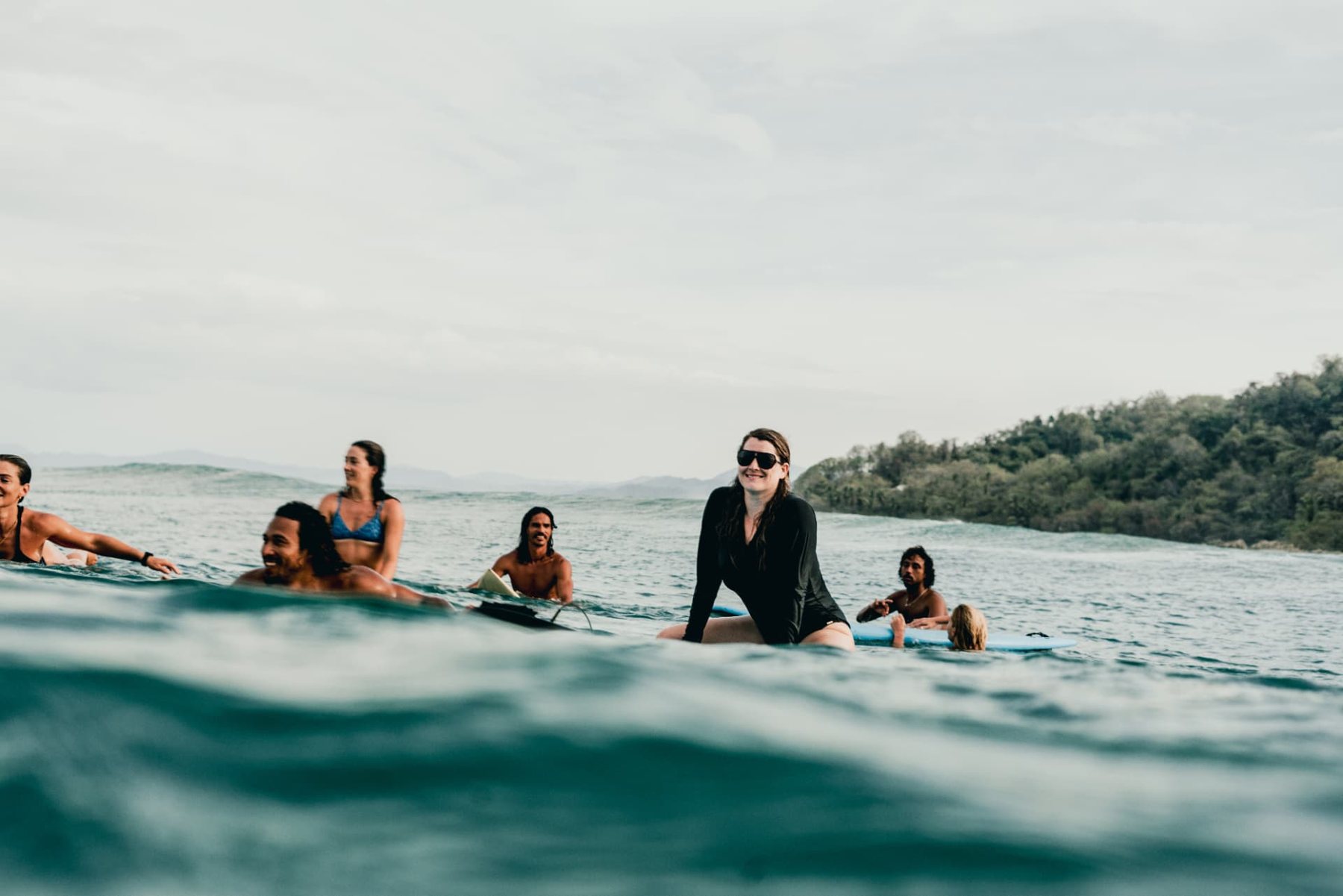The crew sitting on their boards waiting for the next set off the Nicoya coast